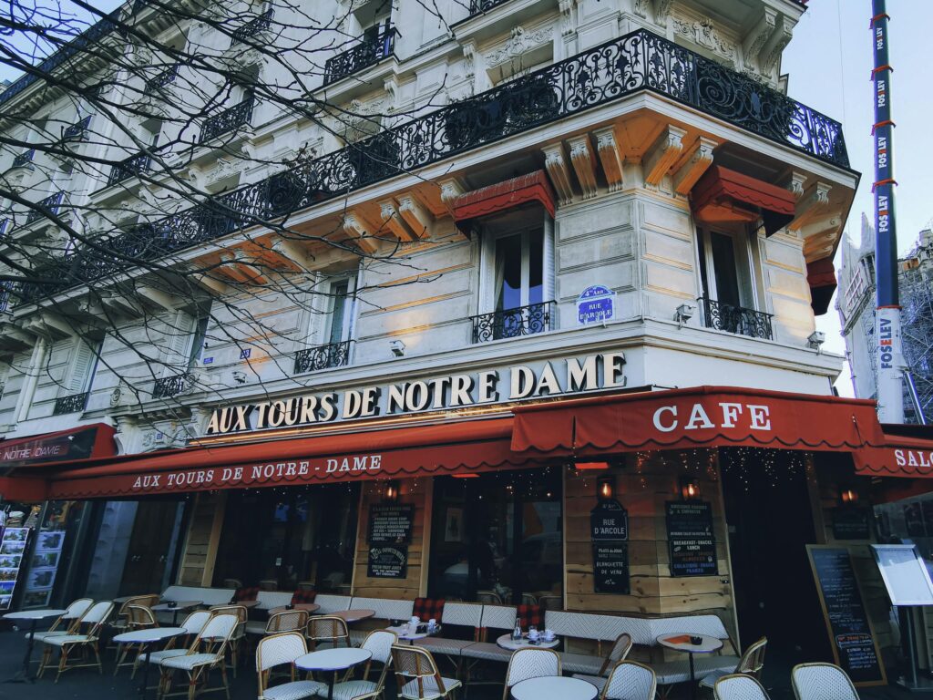 Elegant cafe facade with Parisian architecture near Notre Dame Cathedral.