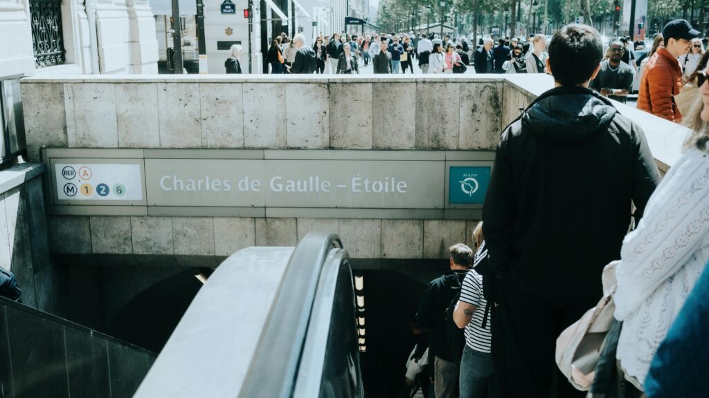 Crowds entering and exiting the Charles de Gaulle–Étoile metro station in Paris, France.