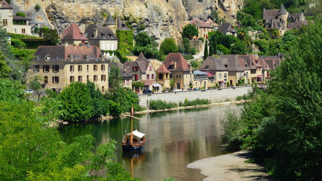 Picturesque village by the river with charming architecture and lush greenery.